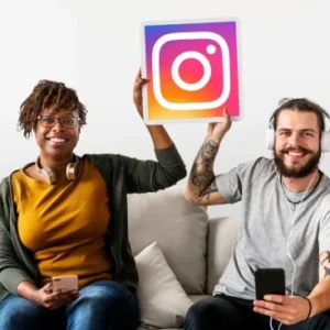 Smiling man and woman holding phones and an Instagram logo, representing how automatic Instagram likes work in the background without logins or dashboards.