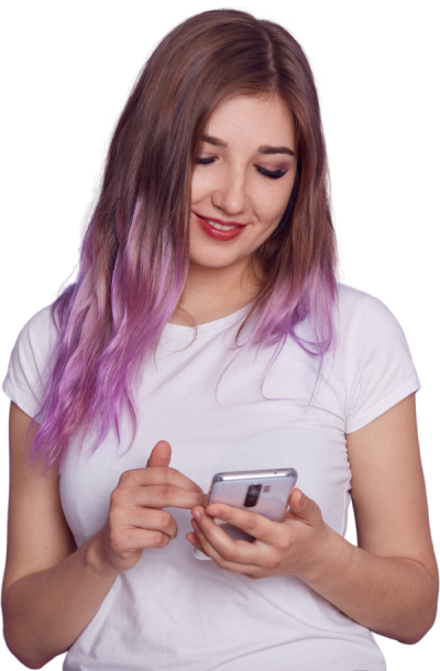 Young woman smiling while using her phone, representing a user who just chose to buy Instagram comments for better engagement.