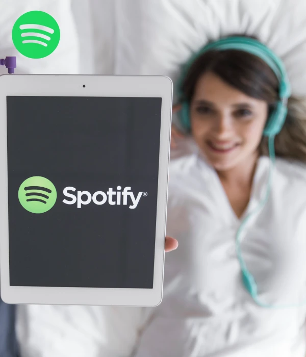Relaxed listener streaming Spotify on a tablet, showing how monthly listeners grow with steady engagement