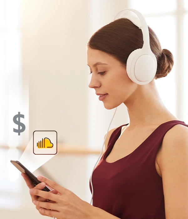 Young woman in headphones looking at her phone, exploring how to buy SoundCloud plays to grow her track’s reach.