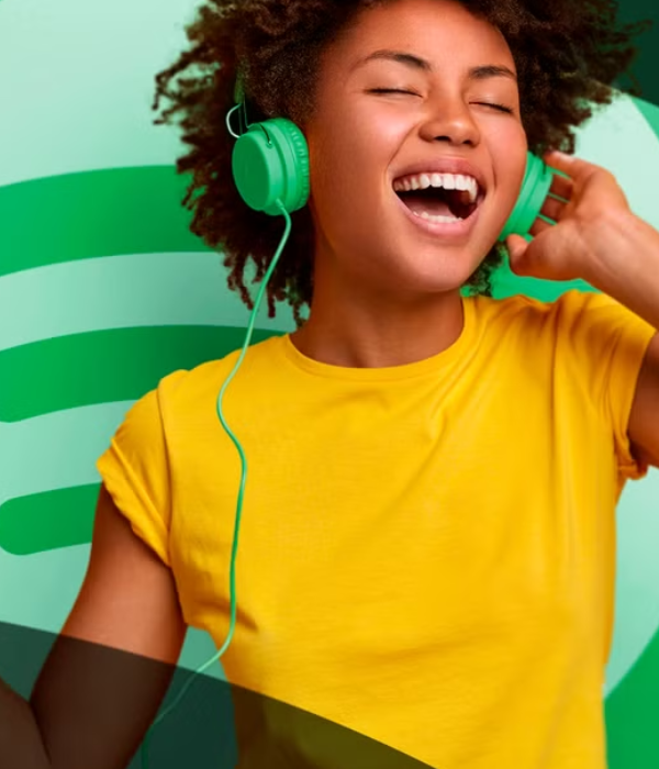 Woman enjoying music with headphones, capturing the joy artists aim for when they buy Spotify plays cheap to boost visibility.