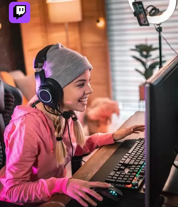 Young girl smiling while streaming in a cozy gaming setup, showing excitement after buying Twitch viewers to boost her live stream