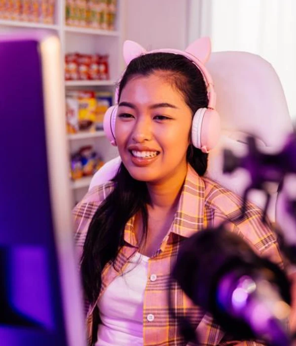 Gamer with cat-ear headphones chatting live, wondering how to get more followers on Twitch without spamming.